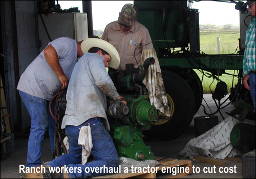 ranch workers overhauling tractor engine